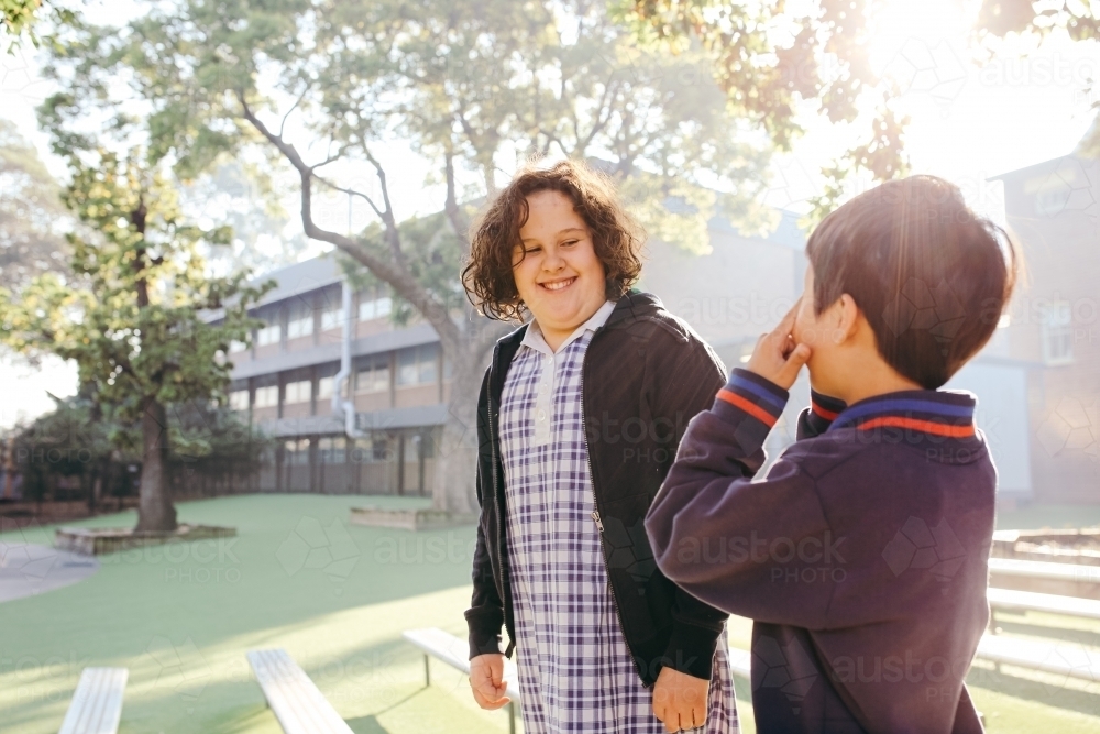 Image of Happy primary school students together outside - Austockphoto