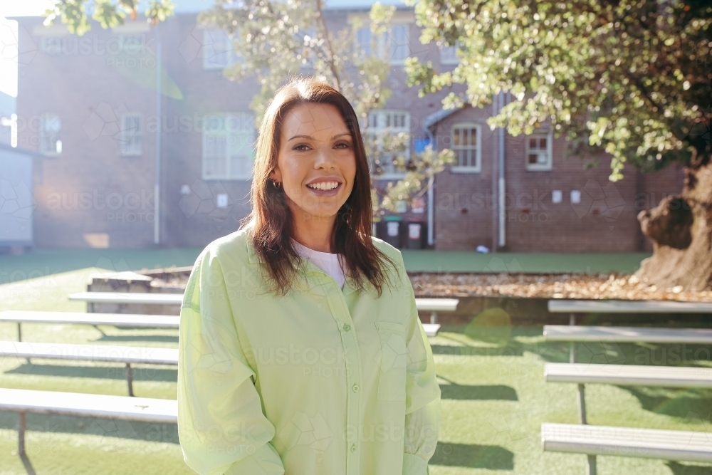 Happy primary school teacher - Australian Stock Image