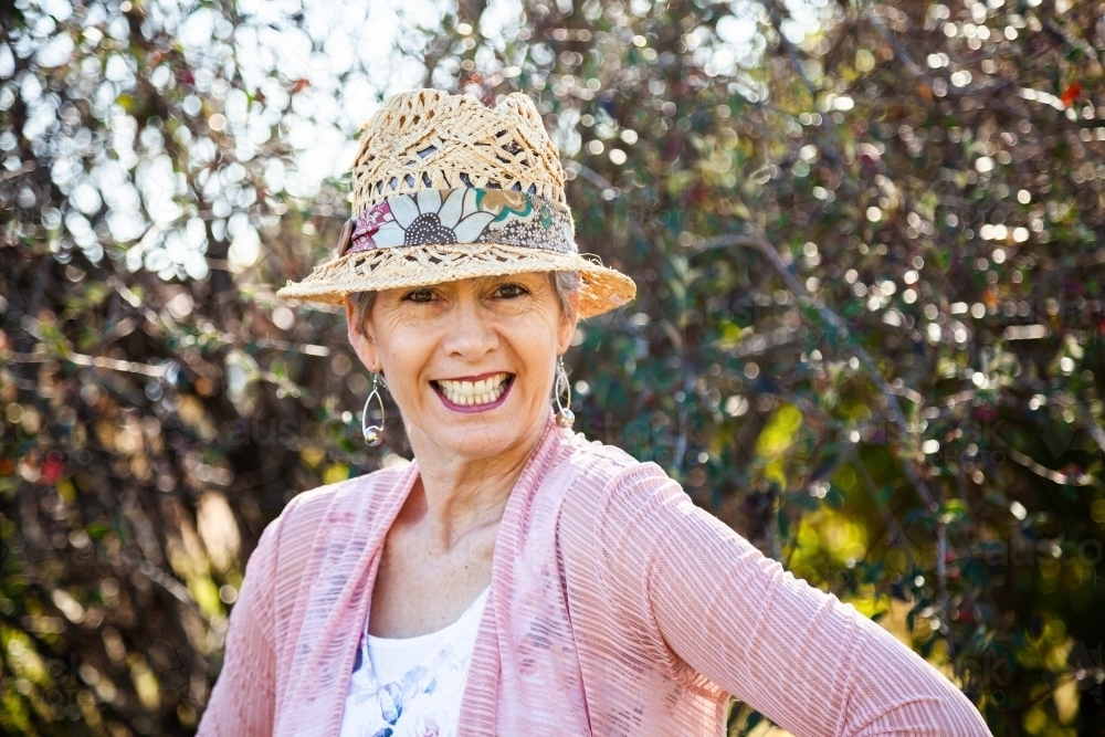 Happy senior woman with a big grin outside in the garden - Australian Stock Image