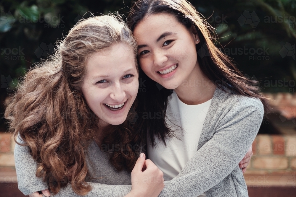 Happy students girl friends - Australian Stock Image