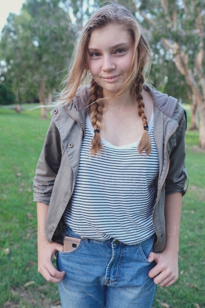 Happy teenage girl in the park - Australian Stock Image