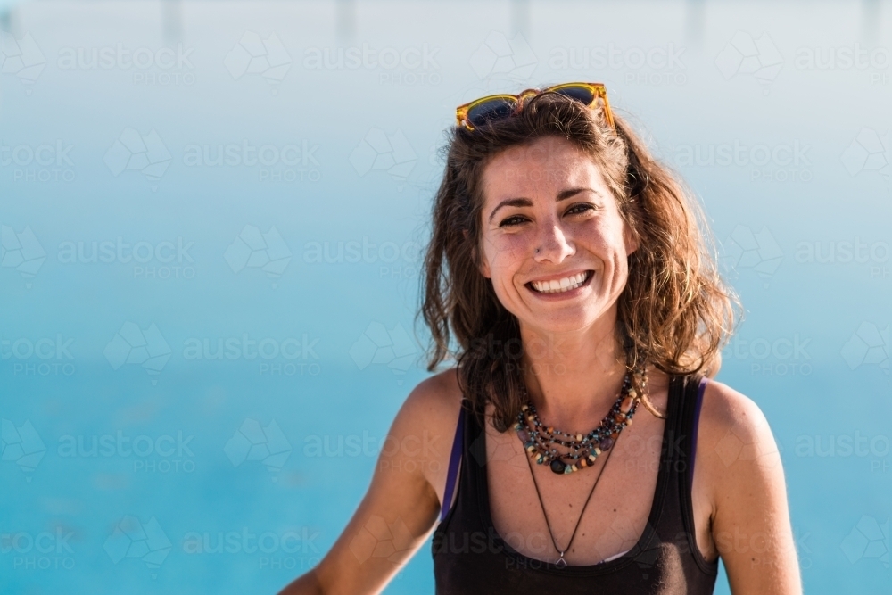 happy woman at ocean swimming pool - Australian Stock Image