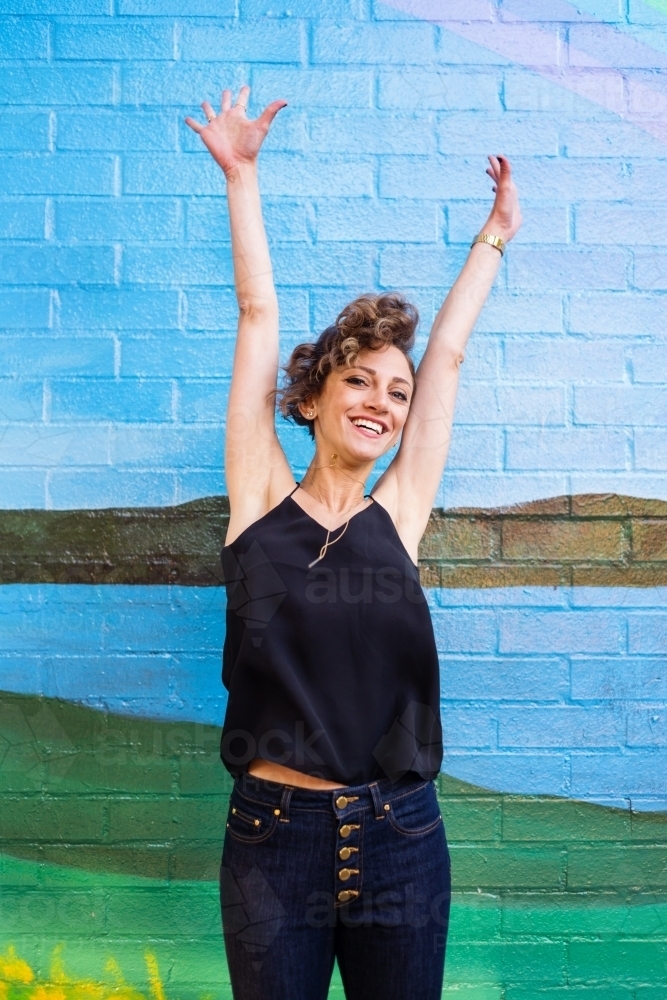 happy woman jumping - Australian Stock Image