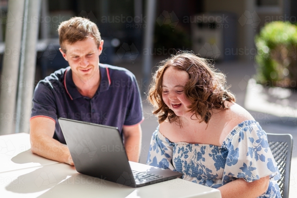 Happy young person with disability doing one on one activity with her NDIS provider - Australian Stock Image