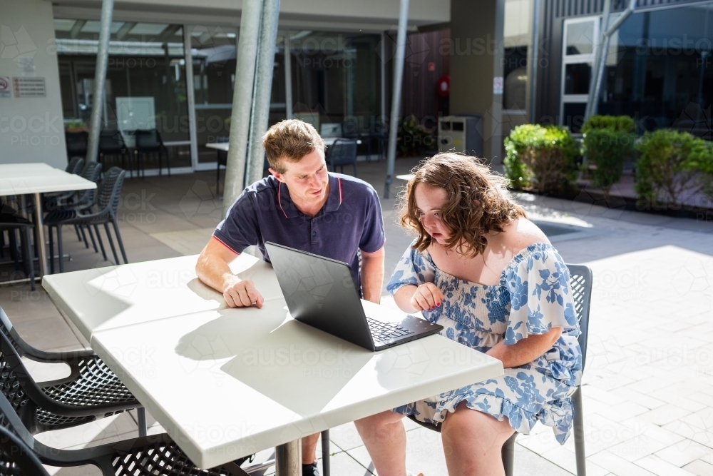 Happy young person with disability doing one on one activity with her NDIS provider - Australian Stock Image