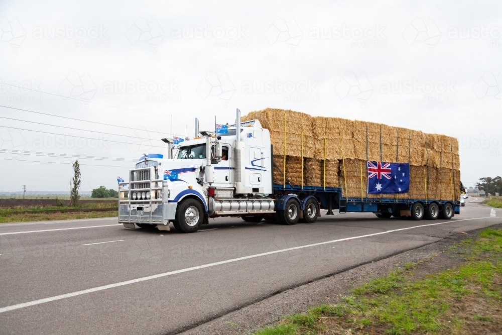 Hay in road train being transported across Australia to aid farmers in drought - Australian Stock Image