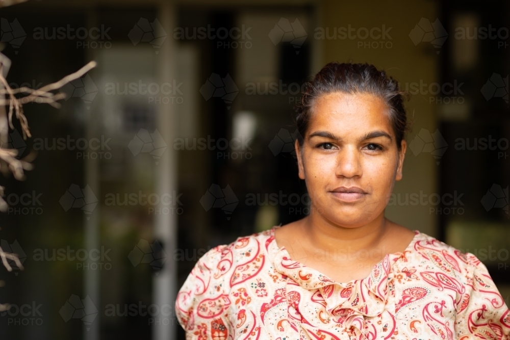 head and  shoulders of young woman looking out from veranda - Australian Stock Image