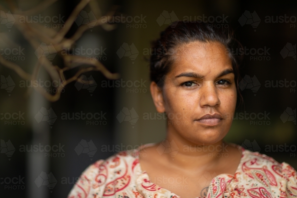 head and  shoulders of young woman looking out from veranda - Australian Stock Image