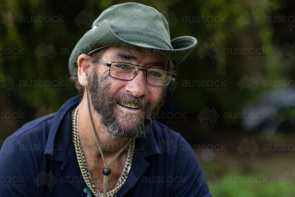 Image of Head and shoulders portrait of a homeless man wearing a hat ...