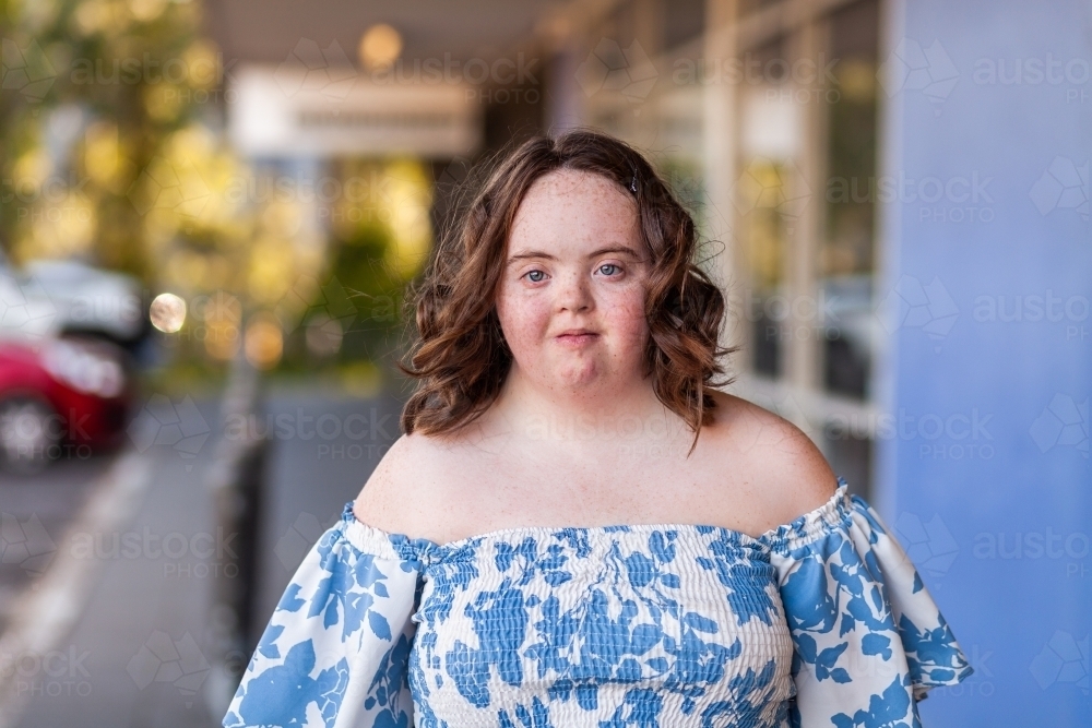 Headshot of teen girl with down syndrome outside shops - Australian Stock Image