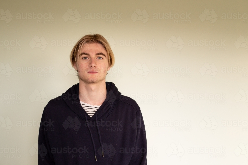 Headshot of teenage boy wearing black hoodie - Australian Stock Image