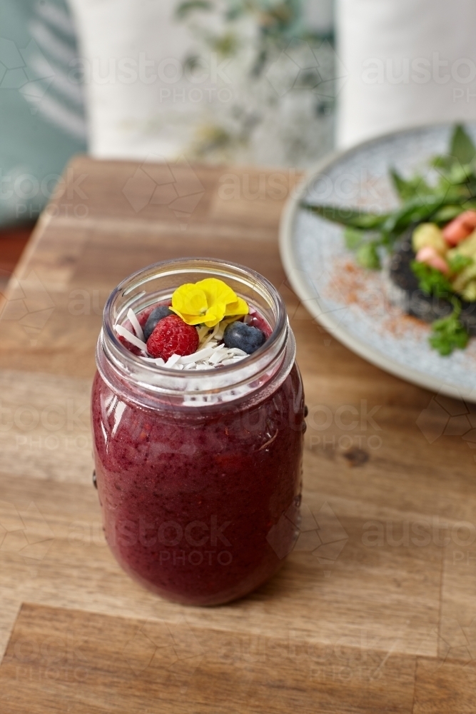 Healthy organic purple berry smoothie drink - Australian Stock Image