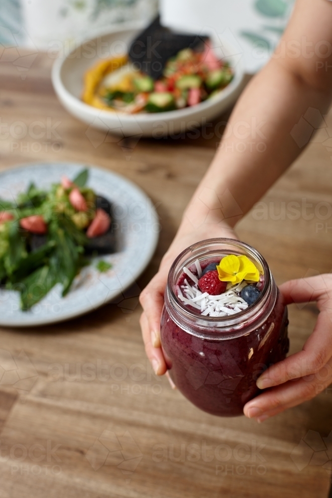 Healthy organic purple berry smoothie drink - Australian Stock Image