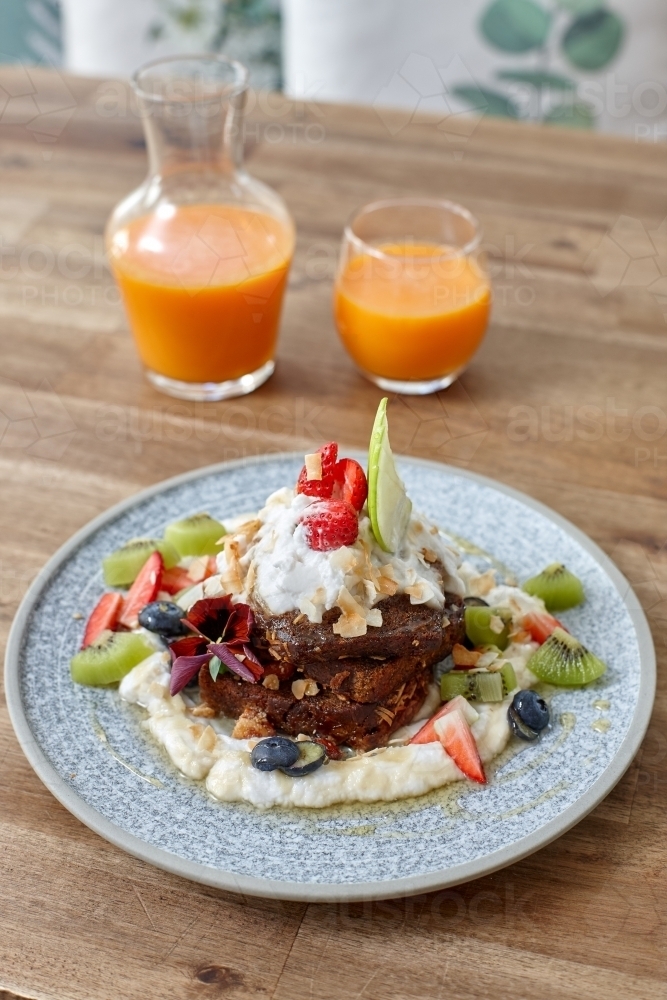 Healthy organic vegan food and drinks on wooden table - Australian Stock Image