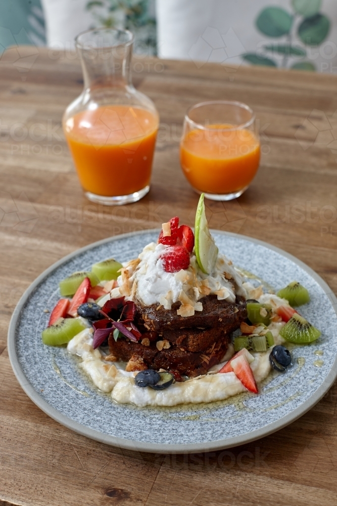 Healthy organic vegan food and drinks on wooden table - Australian Stock Image