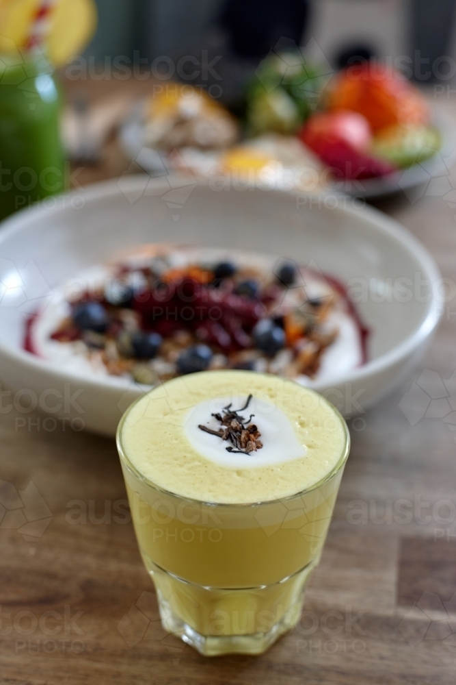 Healthy porridge served with hot beverage in vegetarian cafe - Australian Stock Image