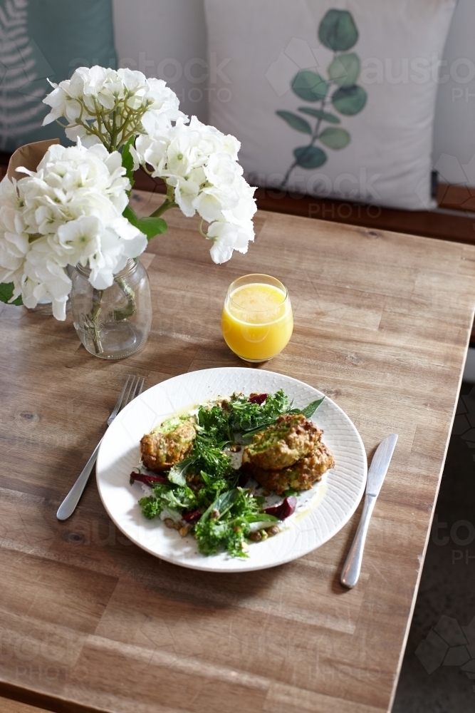 Healthy vegetarian falafel and salad dish on wooden table - Australian Stock Image