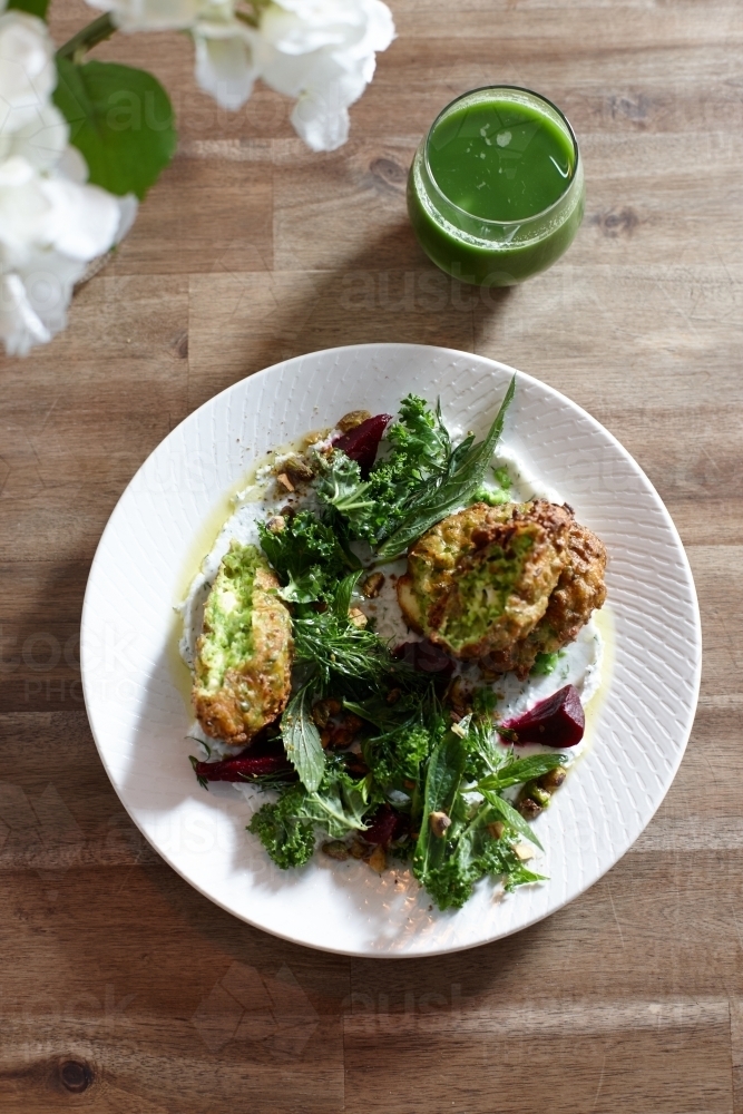 Healthy vegetarian falafel and salad dish on wooden table - Australian Stock Image