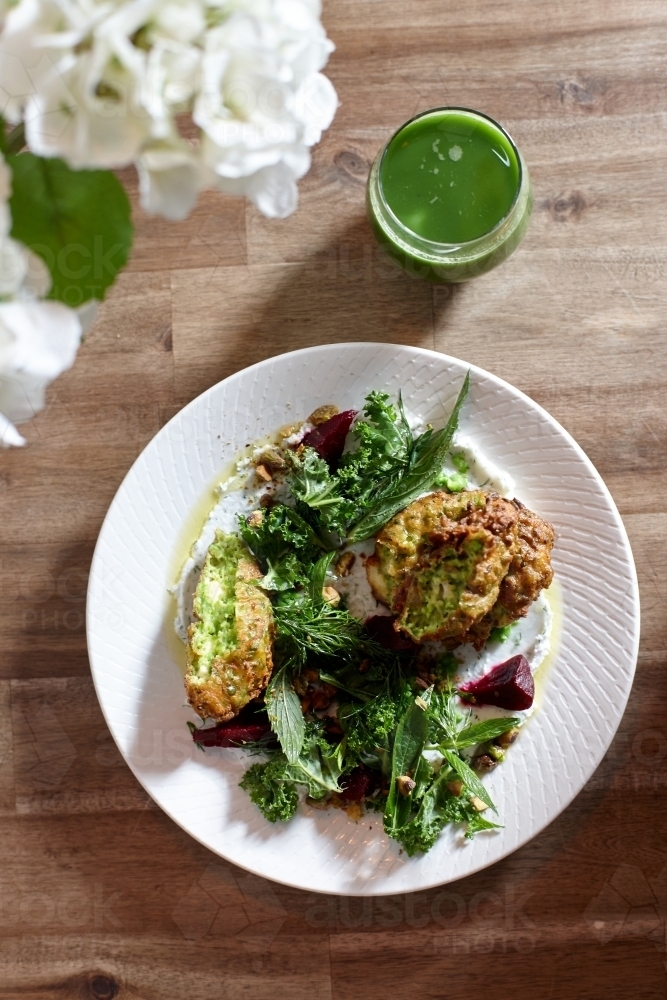 Healthy vegetarian falafel and salad dish on wooden table - Australian Stock Image