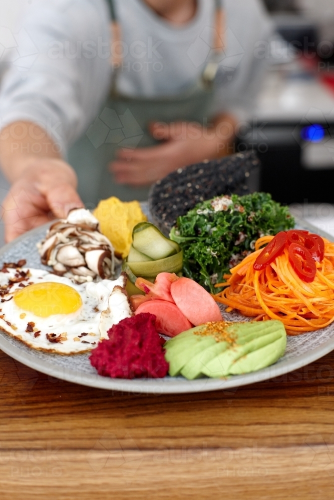 Healthy vegetarian meal being served on table - Australian Stock Image