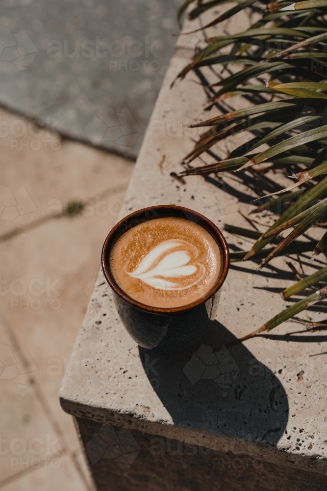 Heart latte coffee art in ceramic cup on a marble tile. - Australian Stock Image