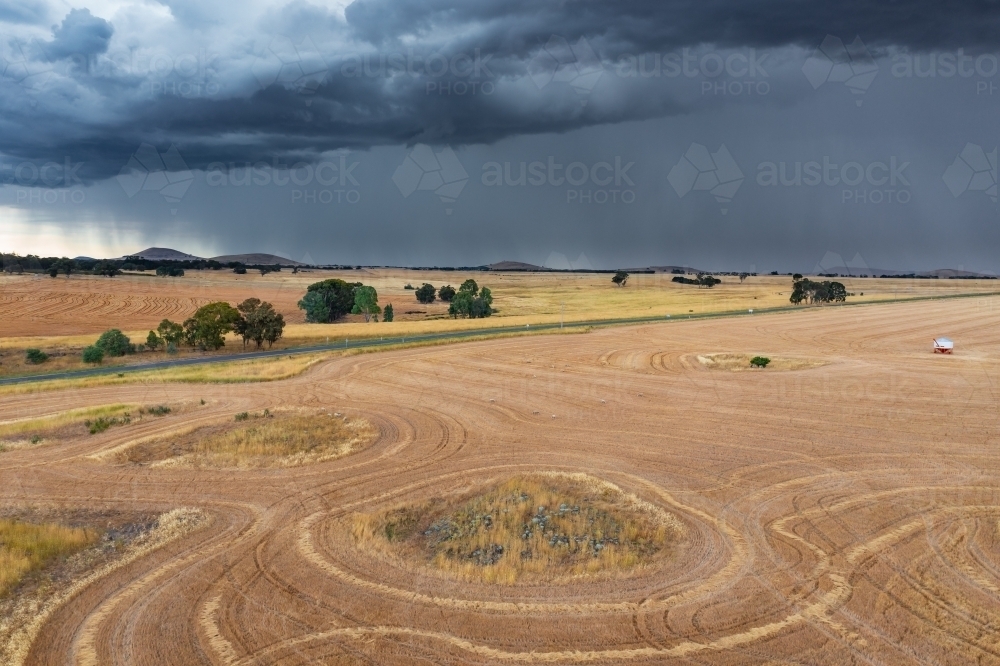 Image Of Heavy Rain And Dark Cloud Over Dry Harvested Paddocks