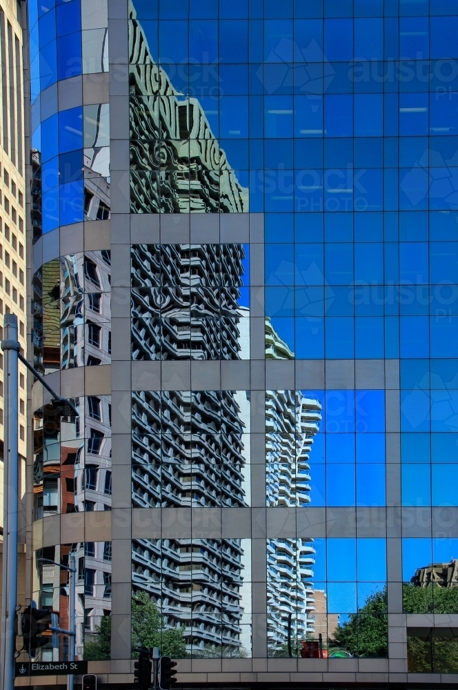 High-rise buildings in Elizabeth Street, Sydney, reflected in glass of adjacent buildings - Australian Stock Image