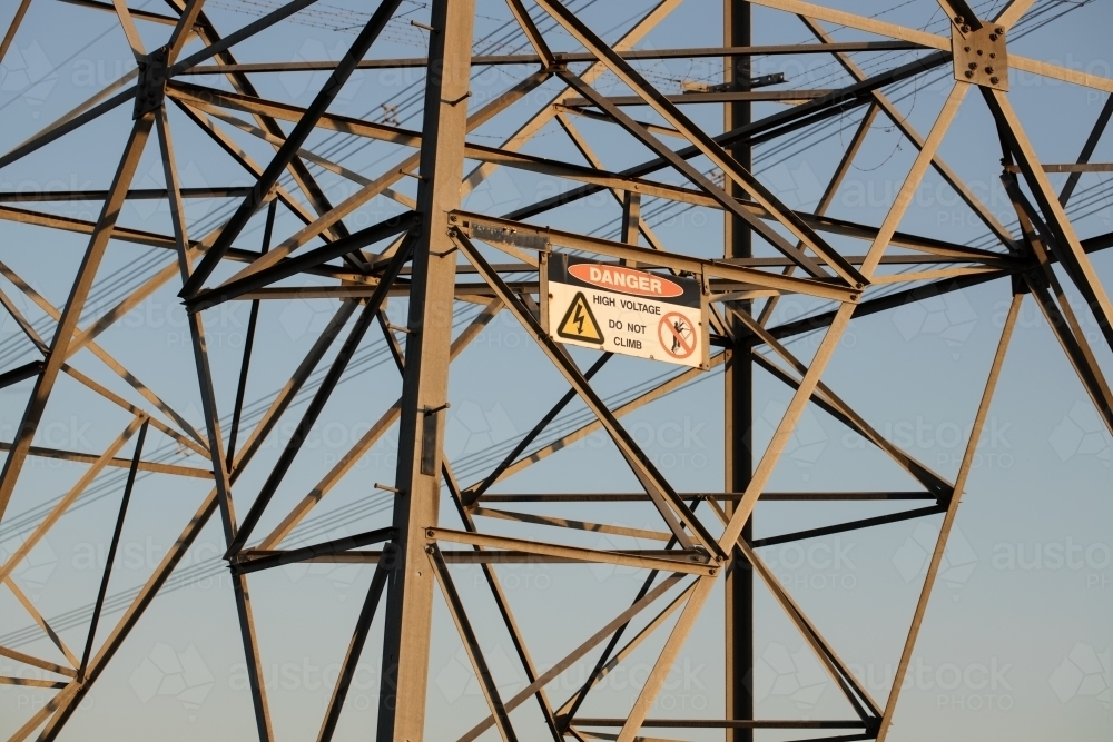 high voltage power lines with a Danger HIgh Voltage sign - Australian Stock Image