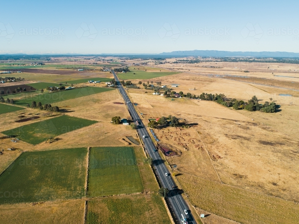 Highway into singleton before bypass cutting through farm paddocks - Australian Stock Image