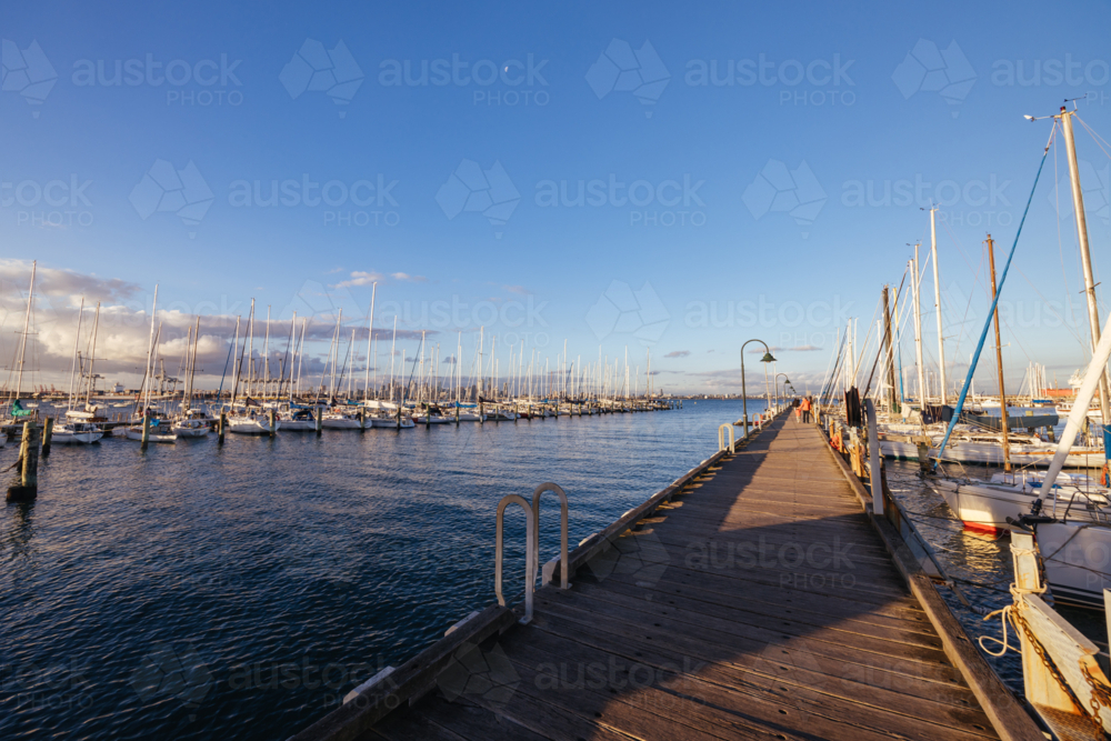 Hobsons Bay around Ferguson St Pier in Williamstown waterfront at dusk in winter in Victoria - Australian Stock Image