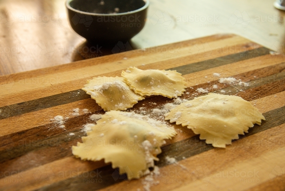 Home made ravioli on a timber chopping board - Australian Stock Image