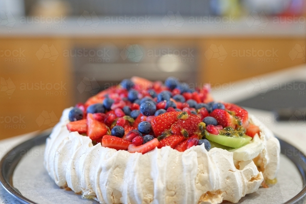 Home made traditional Australian Pavlova with fruit and cream - Australian Stock Image