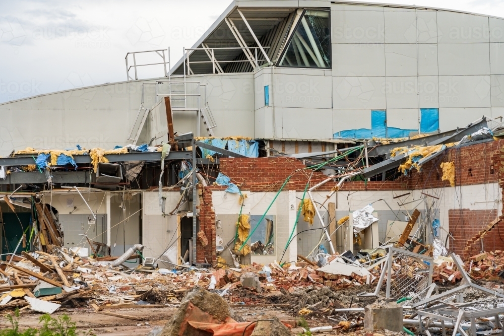 Horizontal shot of a partly demolished stadium with building materials laying in the foreground - Australian Stock Image