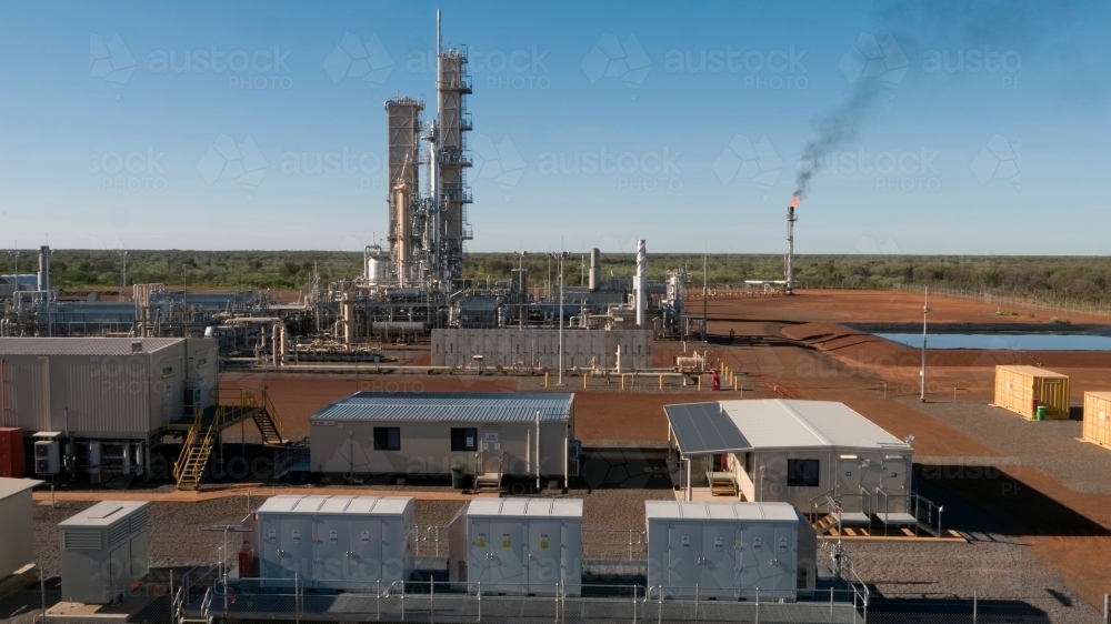 Horizontal shot of a power plant with a smoking flue-gas stack - Australian Stock Image