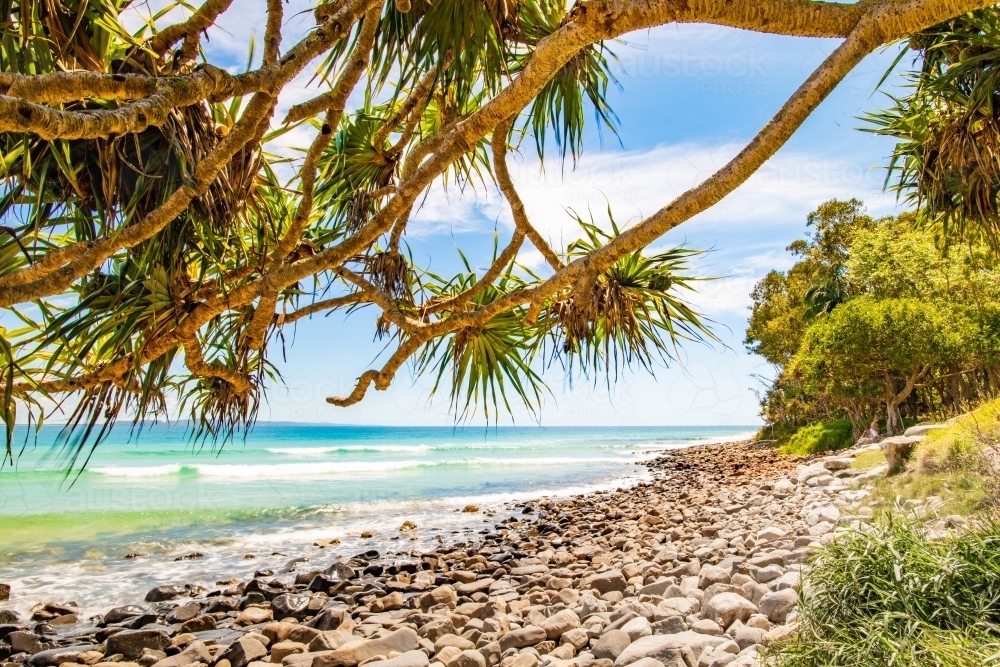 Horizontal shot of a rocky seashore on a sunny day - Australian Stock Image