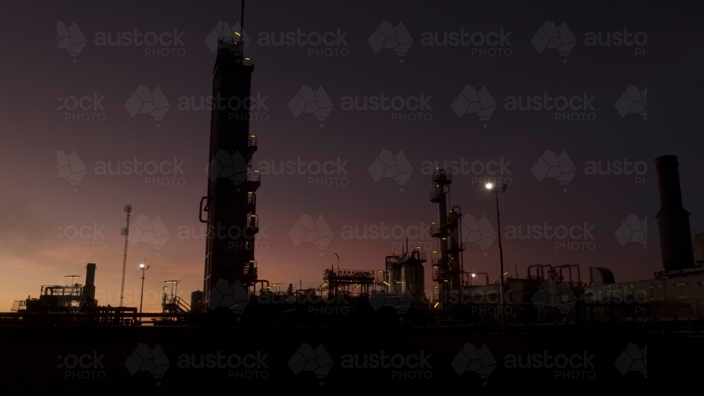 Horizontal shot of an industrial plant after sunset - Australian Stock Image