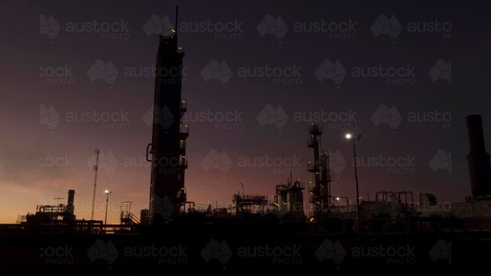 Horizontal shot of an industrial plant at dawn/night - Australian Stock Image