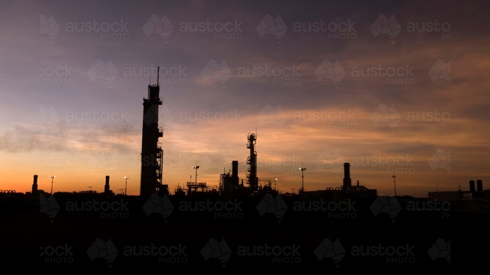 Horizontal shot of an industrial plant at dawn/night - Australian Stock Image