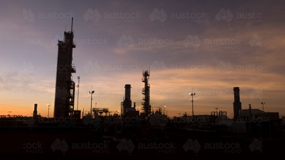 Horizontal shot of an industrial plant at sunset - Australian Stock Image