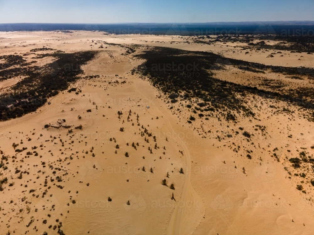 horizontal shot of an outback near the ocean with green bushes on a sunny day with clear skies - Australian Stock Image