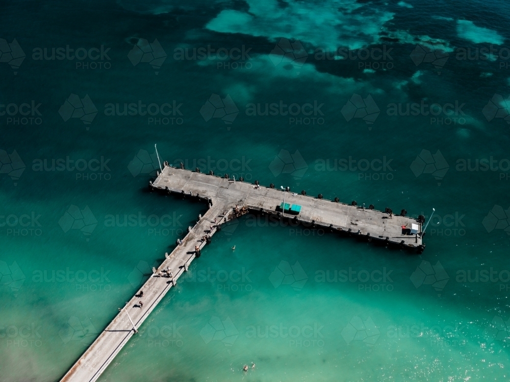 horizontal shot of beach walkway with people, and lamp posts on a sunny day - Australian Stock Image