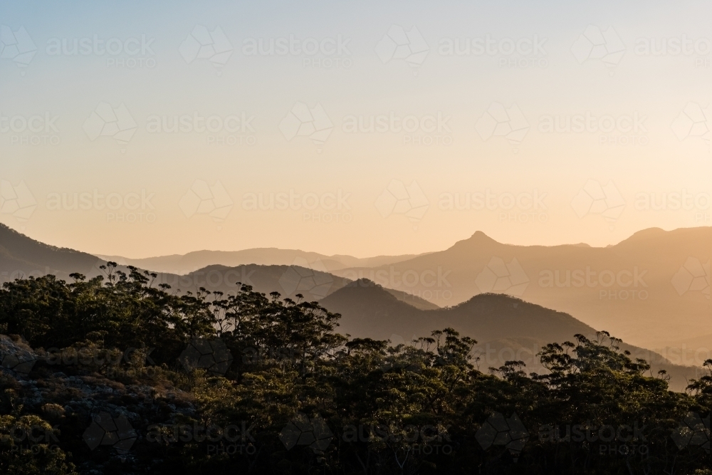 Horizontal shot of mountain ranges at sunset - Australian Stock Image