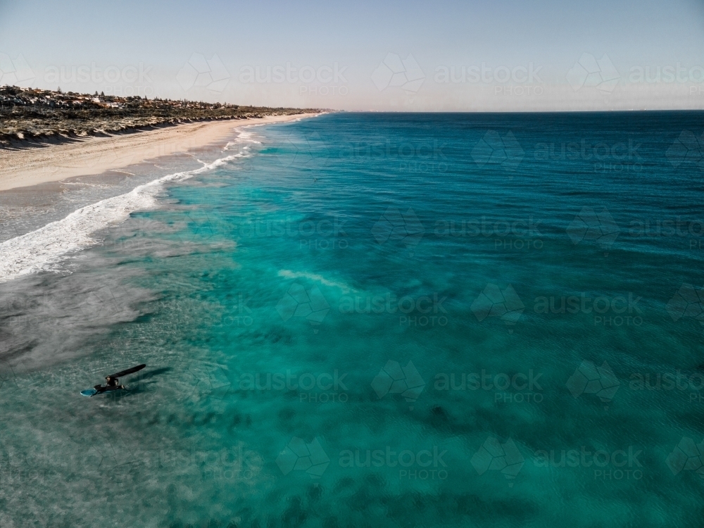 horizontal shot of  ocean water with waves white sand shores, trees, bushes, on a sunny day - Australian Stock Image