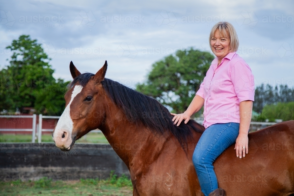 Horsewoman sitting on her horse bareback - Australian Stock Image