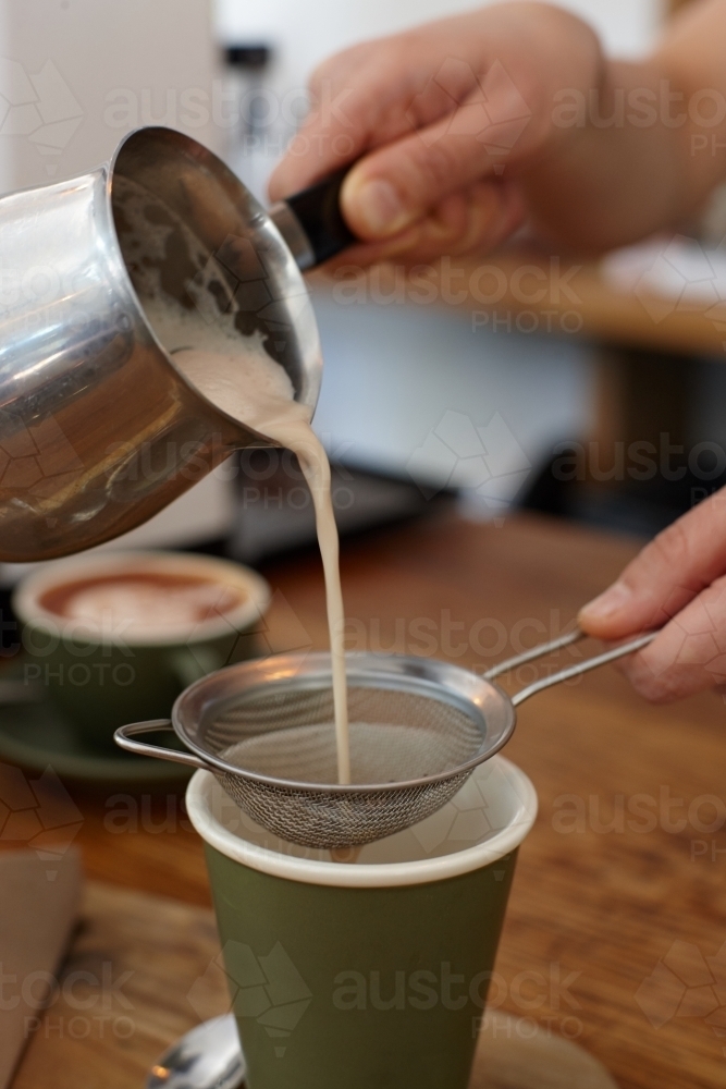 Hot chai latte being prepared by barista - Australian Stock Image