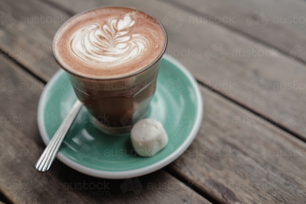 Hot chocolate art on wooden table - Australian Stock Image