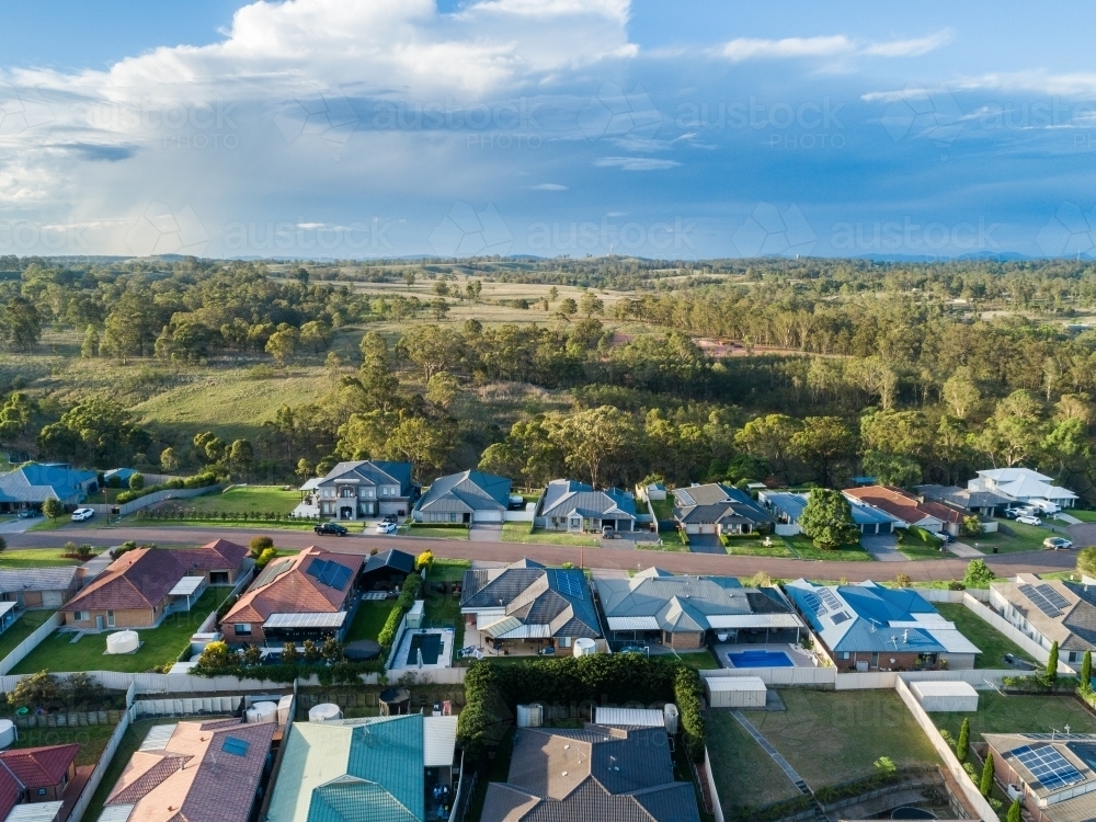 Houses at the edge of development in afternoon light - Australian Stock Image