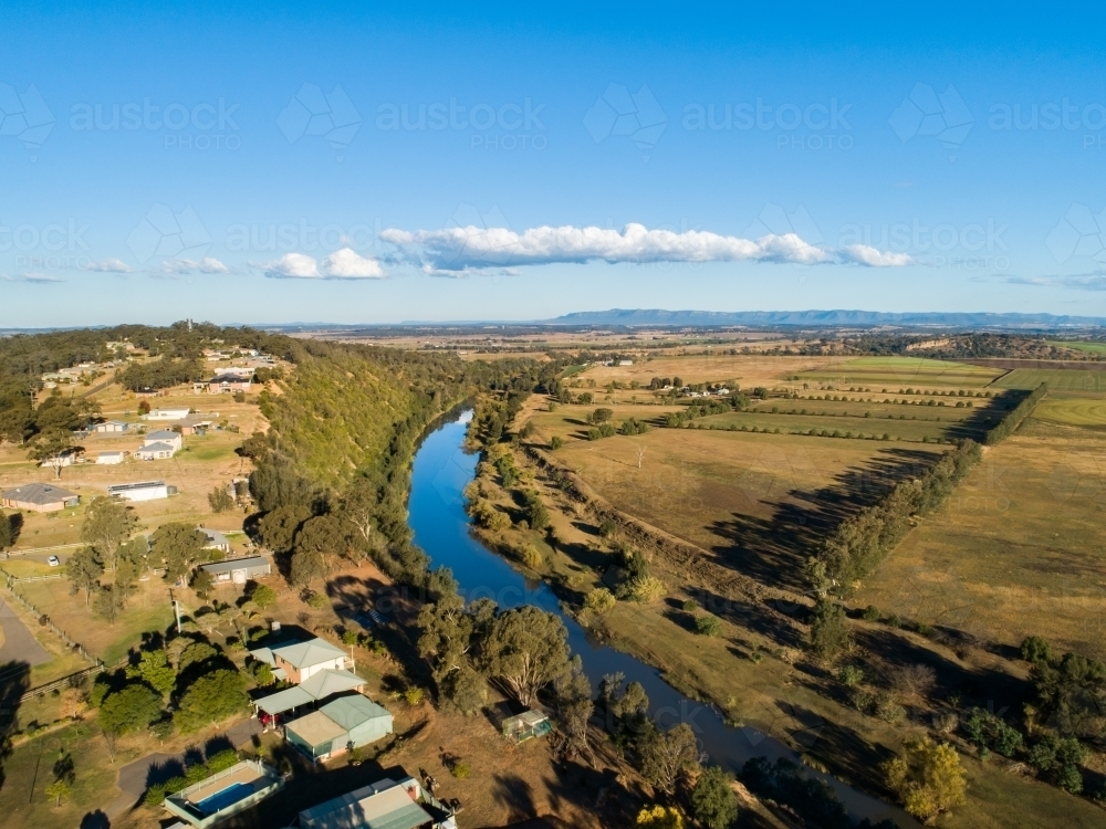 Houses on cliff edge with view over farmland - Australian Stock Image