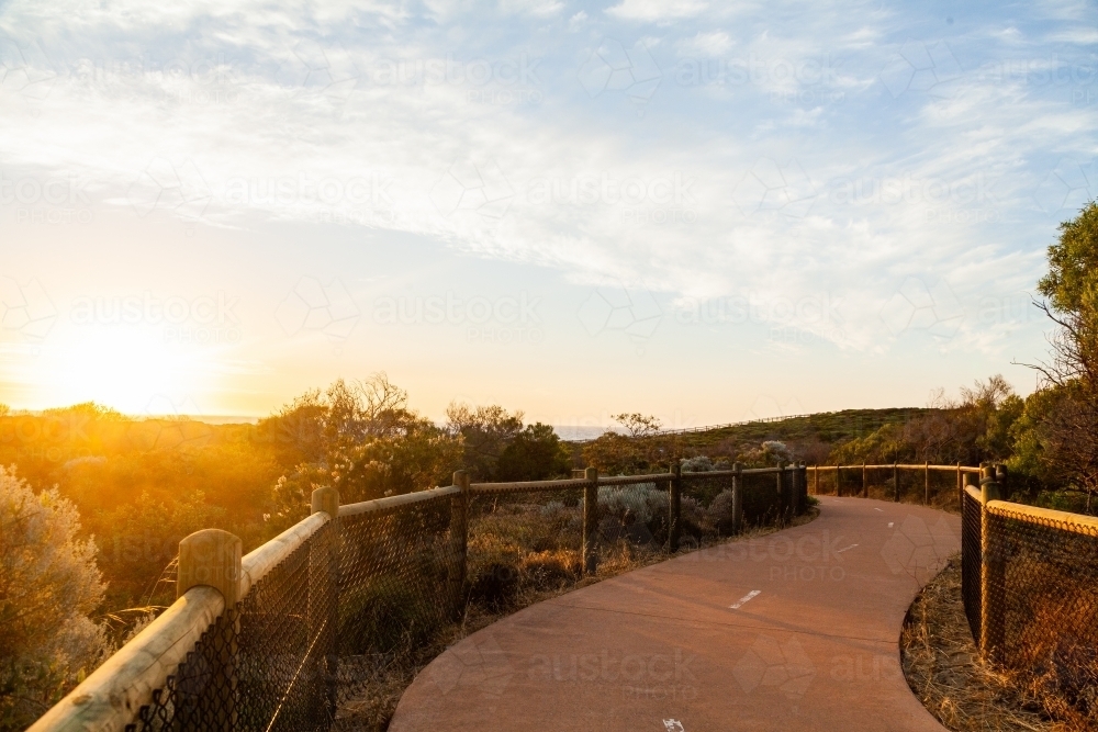 Iluka coastal walk at sunset, walking path between natural coastal vegetation - Australian Stock Image