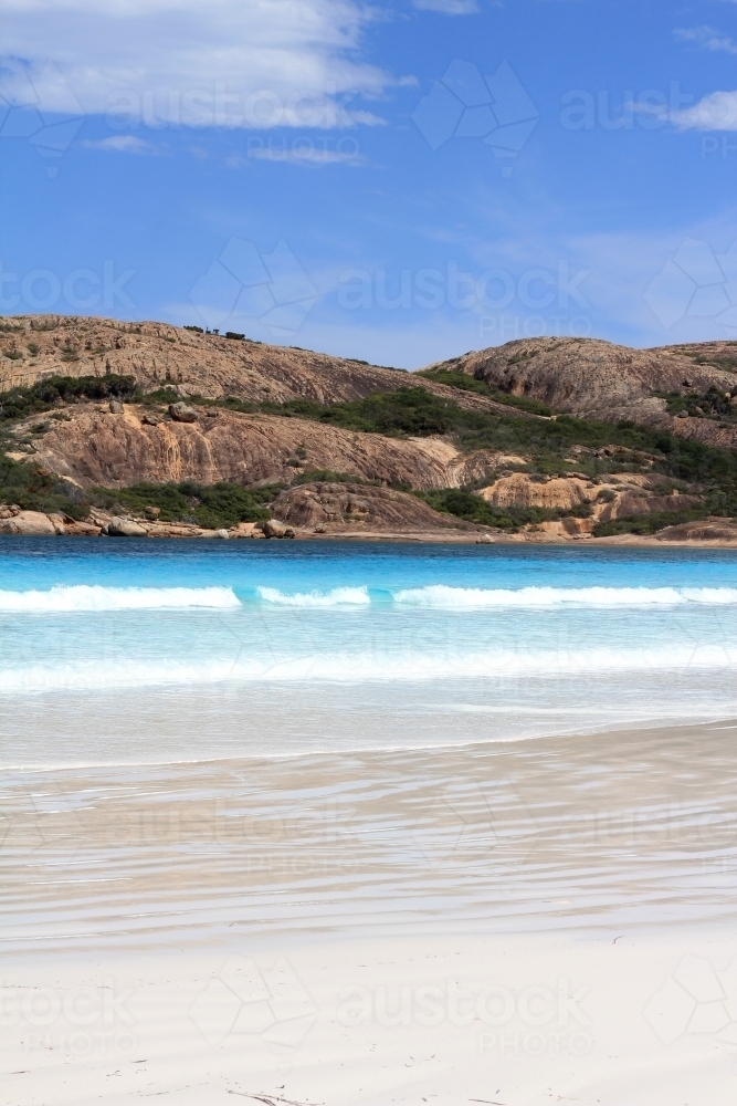 View across ocean towards granite hills - Australian Stock Image